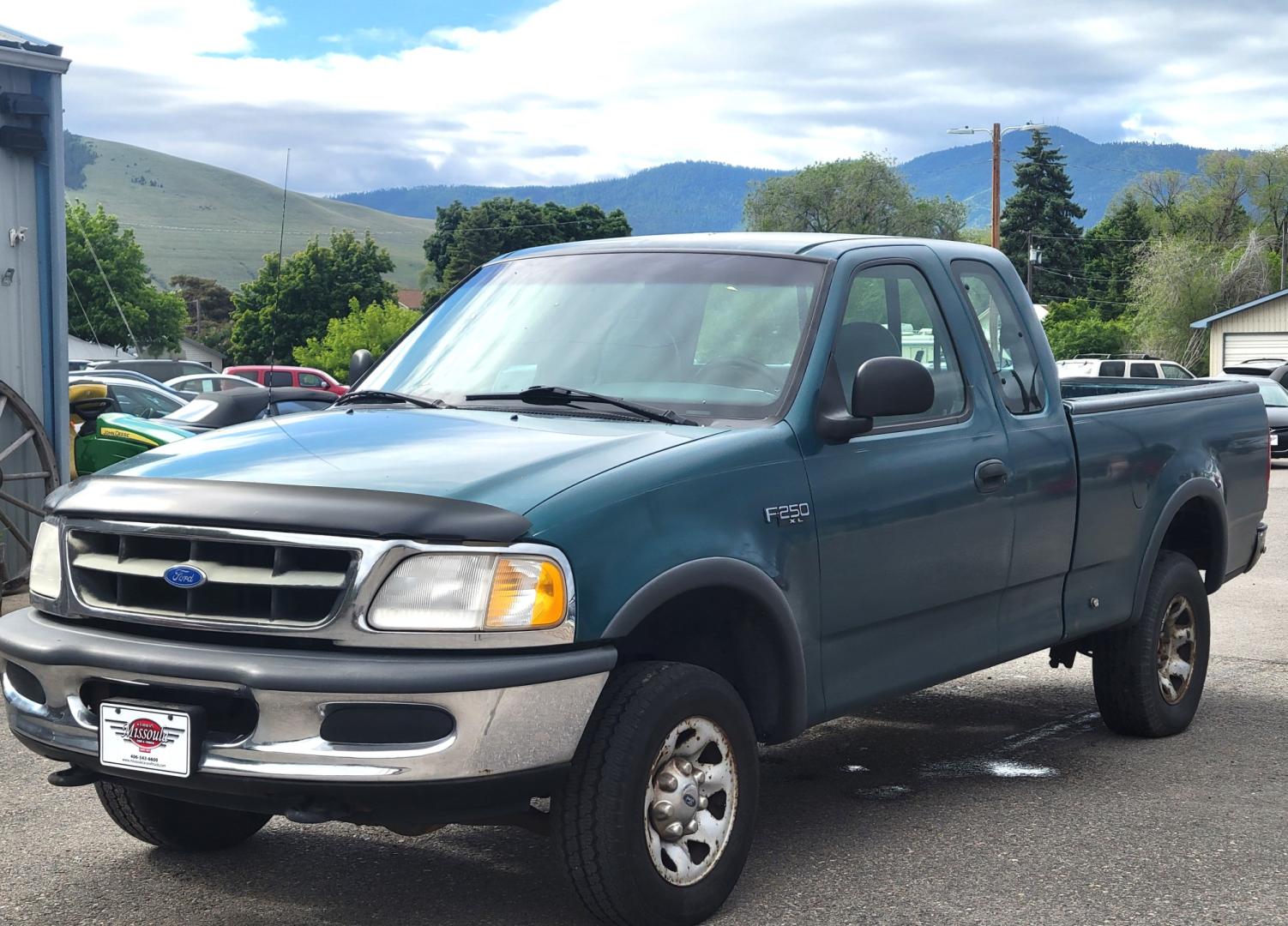 1997 Green /Tan Ford F-250 (1FTFX2866VK) with an 4.6L V8 engine, 4 Speed Manual with Overdrive transmission, located at 450 N Russell, Missoula, MT, 59801, (406) 543-6600, 46.874496, -114.017433 - 4.6L V8 Engine. 4 Speed with Overdrive Manual Transmission. 4 Wheel Drive. 3 Door. Short Box. Air Conditioning. Cruise Control. Financing is NOT Available. - Photo#1